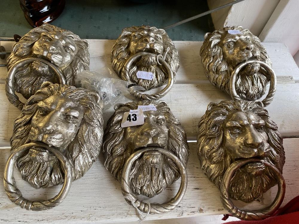 Six silvered Lions head door knockers