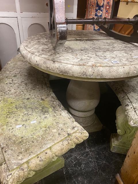 A stone garden table and two stone benches