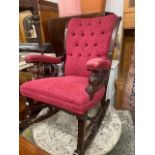 An upholstered button back rocking chair