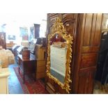 A decorative oval gilt mirror