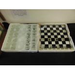 Two chess boards boxed with shot glasses