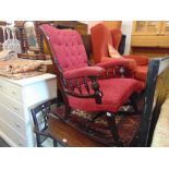 An upholstered button back rocking chair