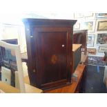 A 19th century inlaid Oak corner cupboard