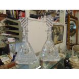 A pair of cut glass decanters with Crown Derby labels