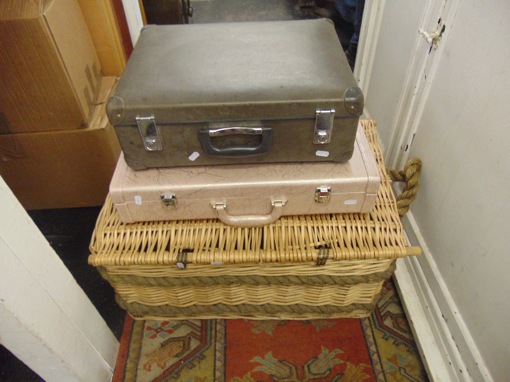 A large wicker basket and two other cases