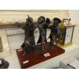 A bronze figural group, Three Jewish men,