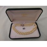 A two row uniform cultured Pearl necklace with 9mm Pearls on a 18ct white gold and Ruby clasp