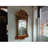 An Empire style gilt and Walnut mirror