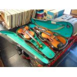 Two old cased violins