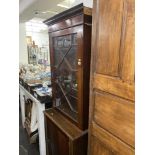 A mahogany bookcase on a cupboard base