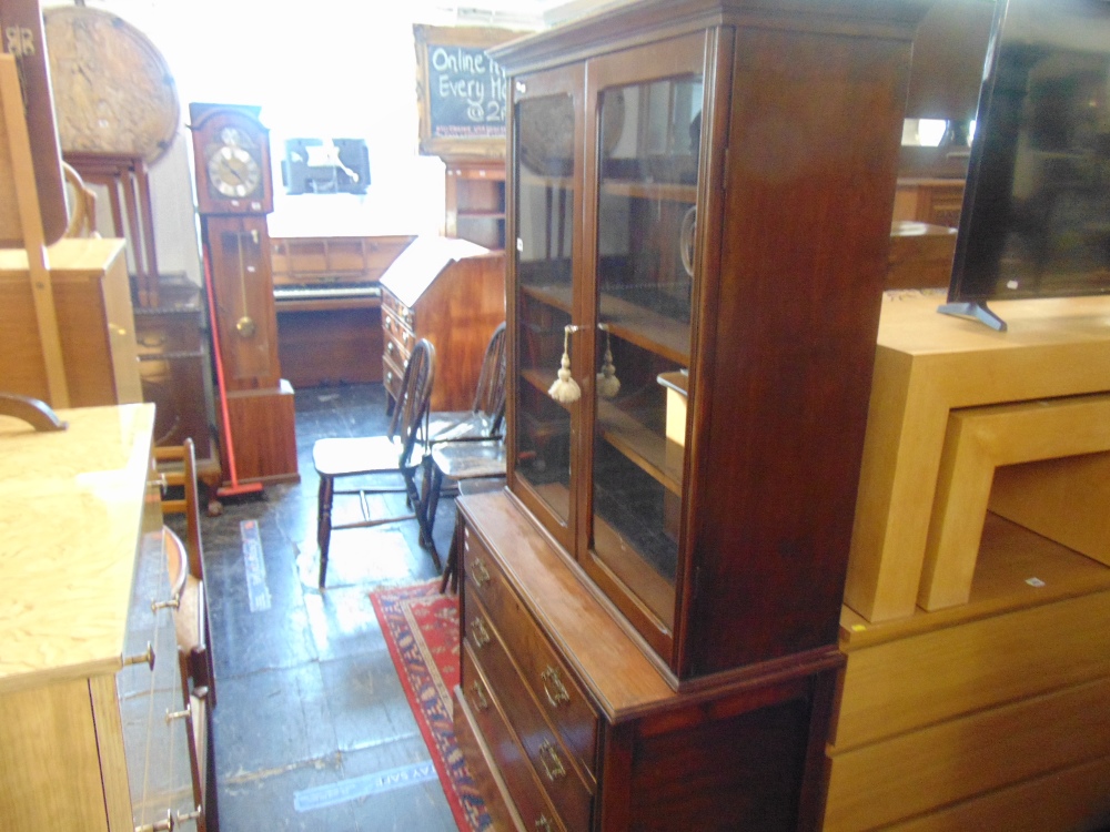 A bookcase over three drawer chest