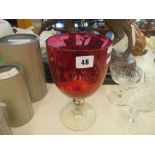 A large cranberry glass goblet,