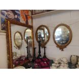 A pair of 19th century oval mirrors,