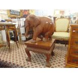 A large wooden Elephant and carved table