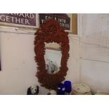 A carved framed mirror