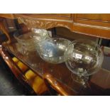 Three large glass bowls and a fruit bowl