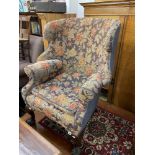 A Victorian armchair on ball and claw feet