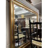 A large contemporary bevelled mirror