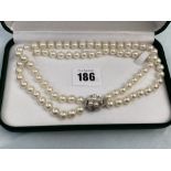 A two row uniform cultured Pearl necklace with Sapphire and Pearl clasp