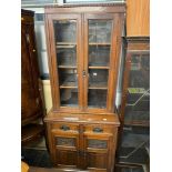 An Edwardian mahogany bookcase with cupboard under