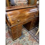 An inlaid mahogany cylinder top desk