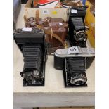 Three folding cameras,