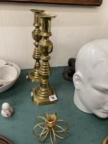 Pair of brass candlesticks plus another