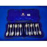 A boxed set of 12 silver spoons and sugar nibs