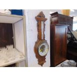 A carved Thermo/barometer,