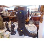 A bronze boot umbrella stand