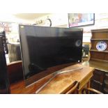 A Samsung curved TV and remote,