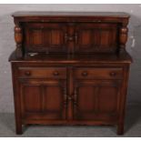 A Ercol Oak court cupboard (126cm height 121cm width) has a paint stain and ring mark on top of
