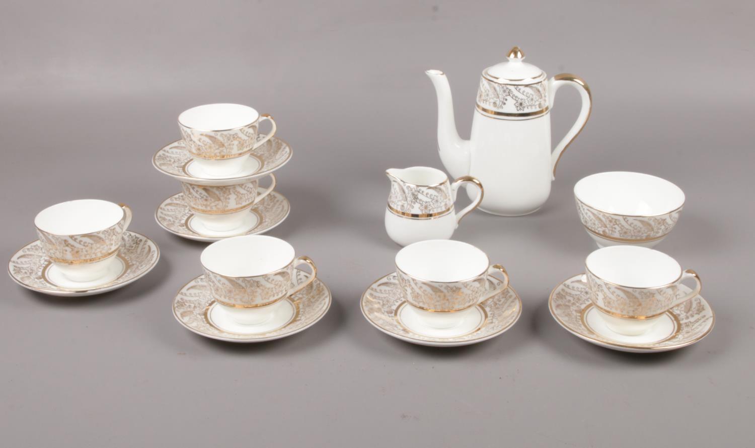 A Bone China Tea set with gilt edge detailing, Teapot, milk jug, sugar bowl, cups, saucers.