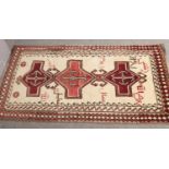 A cream ground wool full pile Iranian Qashqai rug, signed by weaver and dated. (218cm x 118cm).