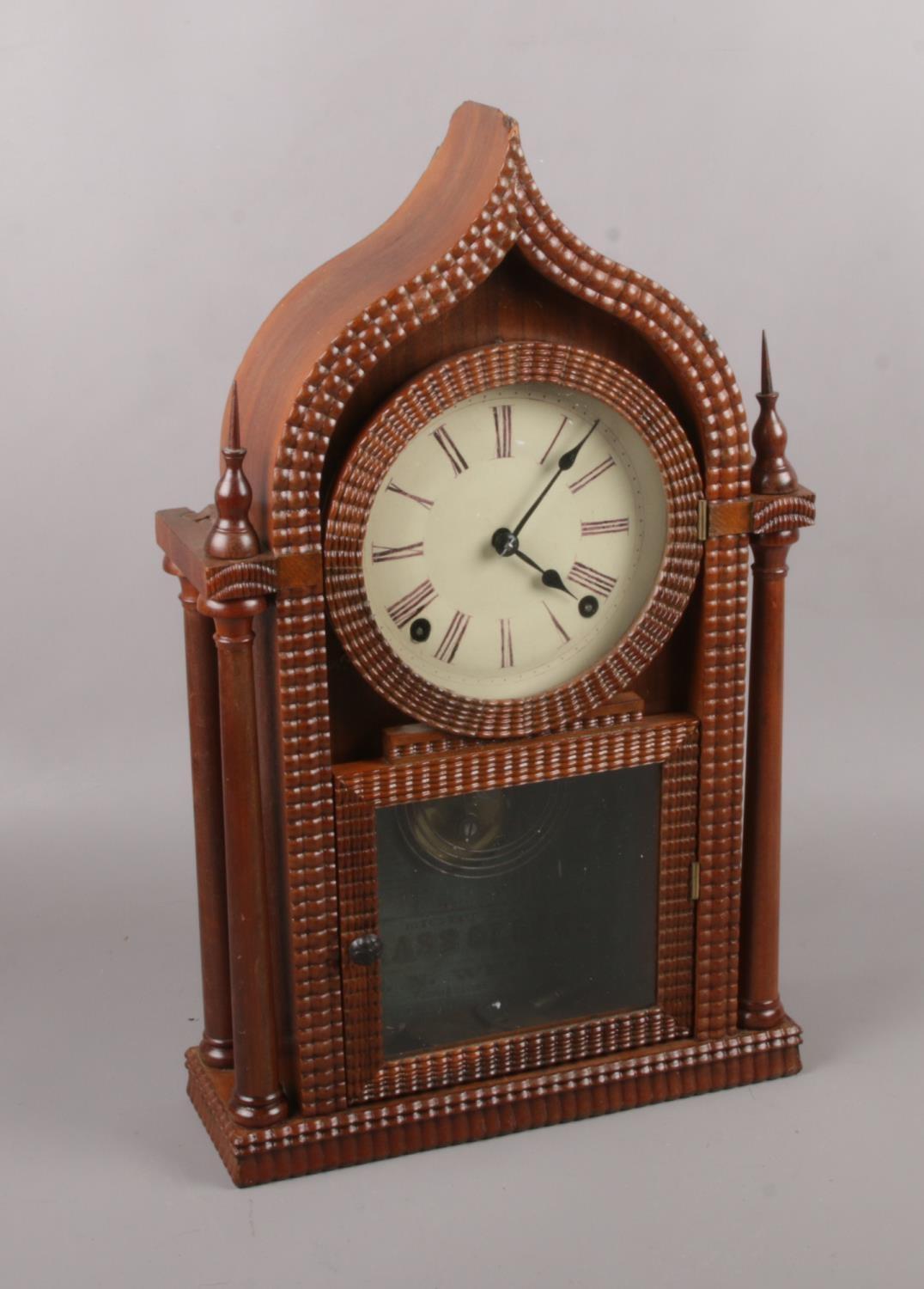 A carved Mahogany gingerbread clock. damage on top of clock