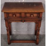 A Titchmarsh & Goodwin carved oak twin drawer side table. (71cm x 61cm)