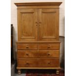 A stained pine linen press. (210cm x 130cm x 48cm) One side has shelves the other side is locked. No