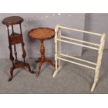 A mahogany plant stand with two drawers along with a painted towel rail and side table.