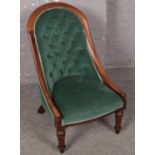 A 19th century mahogany shallow buttoned upholstered nursing chair. Some splits to the wood.