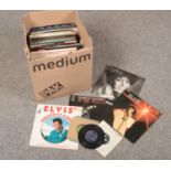 A collection of L.P. vinyl records, Phil Collins, Shirley Bassey, Elvis Presley to include 45 rpm