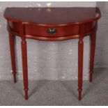 A modern demi loon side table with reeded supports and single drawer.