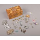 A pokerwork box with contents of jewellery, to include silver and white metal chains, pendants etc.