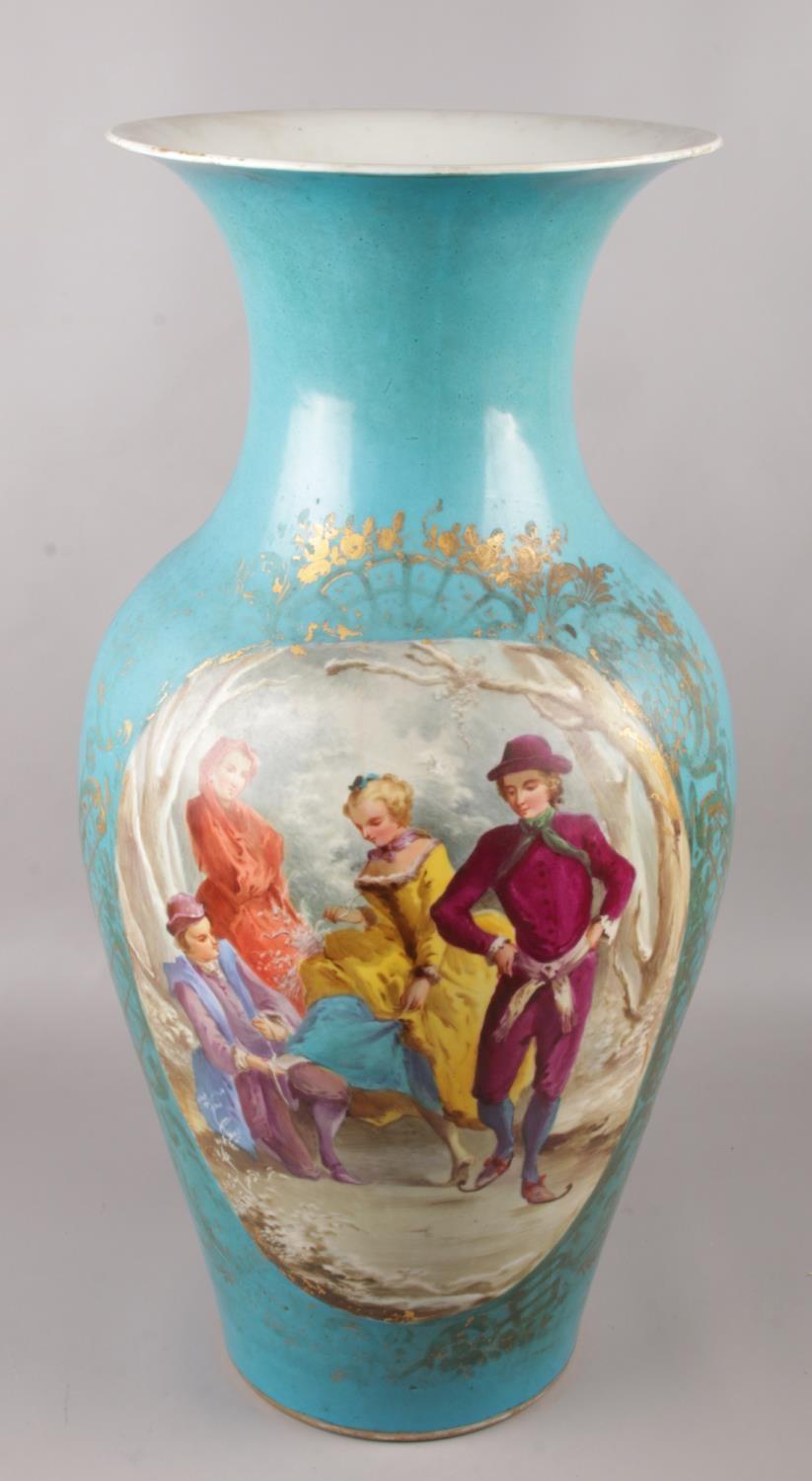 A large 19th century French Sevres style vase, with hand painted panels depicting figures and