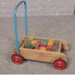 Tri-Ang Baby walker with wooden blocks.