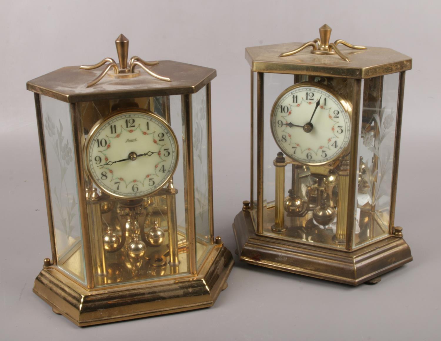 Two brass torsion anniversary clocks, one by Kundo Kieninger & Obergfell, the other by Hall Craft