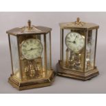 Two brass torsion anniversary clocks, one by Kundo Kieninger & Obergfell, the other by Hall Craft