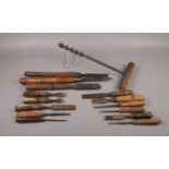 A selection of vintage wooden handled work tools, comprising of various named chisels such as