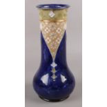 A Royal Doulton stoneware blue ground vase, maker Florrie Jones. (30cm tall)
