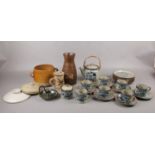 A selection of earthen ware ceramics to include, a teapot, six cups and saucers, milk jug and
