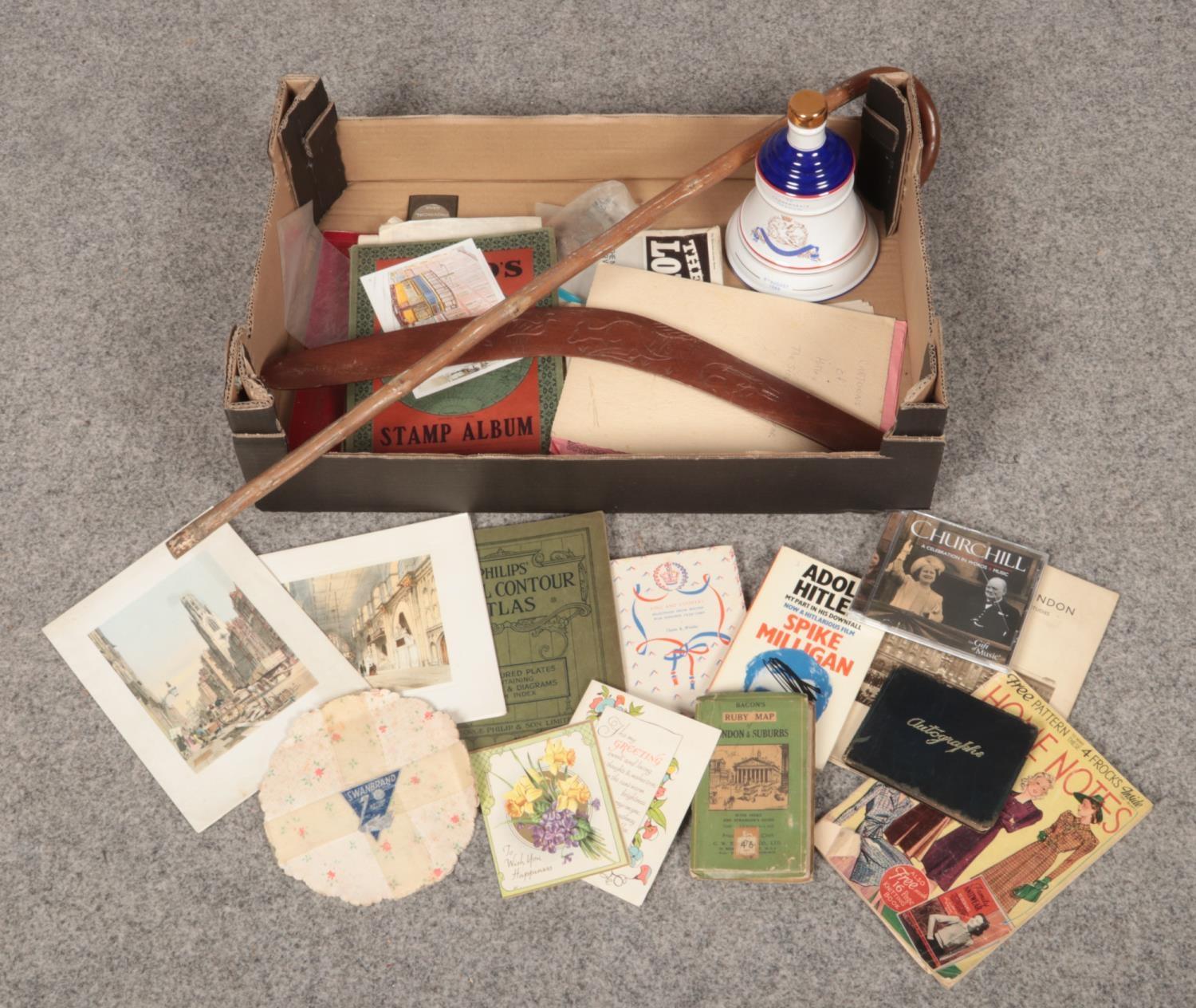 A box of collectables, to include boomerang, walking stick, empty Wade commemorative decanter,